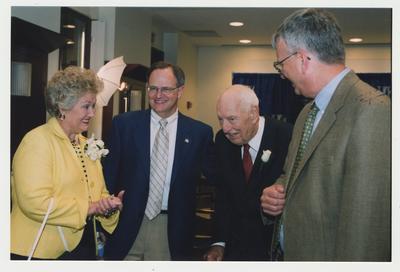 Thomas D. Clark is talking with Patricia B. Todd (left), President Lee Todd (second from left), and William J. Marshall, Director of Special Collections and Archives (right) at Dr. Thomas D. Clark's 100th birthday celebration at Young Library