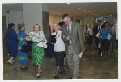William J. Marshall (right) is escorting Loretta Brock (center) into Young Library for Thomas Clark's 100th birthday celebration while Mrs. Amos Lawrence (left) talks