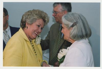 Patricia B. Todd (left) is talking with Loretta Brock (right)  at Dr. Thomas D. Clark's 100th birthday celebration at Young Library.  William J. Marshall, Director of Special Collections and Archives is standing near Patricia Todd and Loretta Brock