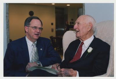 President Lee Todd (left) is talking with Thomas Clark (right)  at Dr. Thomas D. Clark's 100th birthday celebration at Young Library