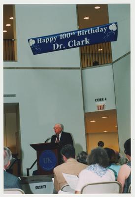 Unidentified men and women are listening to James Klotter, State Historian of Kentucky, speak at Dr. Thomas D. Clark's 100th birthday celebration at Young Library