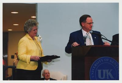 Thomas D. Clark (seated, center, background) and Patricia Todd (left) are listening to President Lee Todd (right) speak at Dr. Thomas D. Clark's 100th birthday celebration at Young Library
