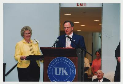 Patricia Todd (left), Thomas Clark (seated, right), and unidentified people are listening to President Lee Todd (center) speak at Dr. Thomas D. Clark's 100th birthday celebration at Young Library