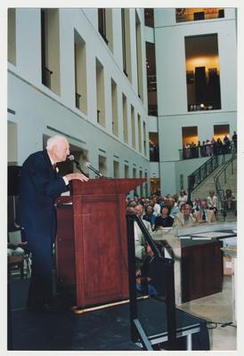 Unidentified people are listening to Thomas Clark (left) speak at Dr. Thomas D. Clark's 100th birthday celebration at Young Library