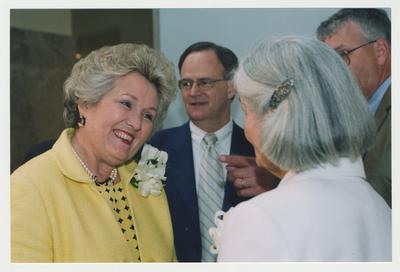 Patricia Todd (left) is talking with Loretta Brock (right).  Behind the women William Marshall (right), Director of Special Collections and Archives, is talking with President Lee Todd (center) at Dr. Thomas D. Clark's 100th birthday celebration at Young Library