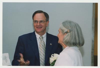 President Lee Todd (left) is talking with Loretta Brock (right) at Dr. Thomas D. Clark's 100th birthday celebration at Young Library