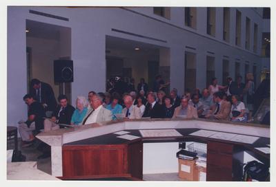 Unidentified men and women are sitting in an audience at Dr. Thomas D. Clark's 100th birthday celebration at Young Library