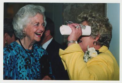 Patricia Todd (right) is talking to Joy Hembree (left), well wisher for Clark, at Dr. Thomas D. Clark's 100th birthday celebration at Young Library