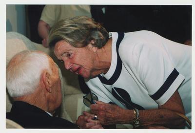 Anne Campbell (Mrs. Alex) (right) is talking with Thomas Clark (left) at Dr. Thomas D. Clark's 100th birthday celebration at Young Library