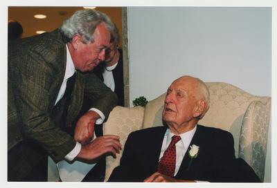 J. Michael Courtney (left), owner of Black Swan Books, is talking with Thomas Clark (right) at Dr. Thomas D. Clark's 100th birthday celebration at Young Library