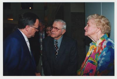 Lt. Colonel Howard Goodpaster (center) and Mrs. Goodpaster (right) are talking with President Lee Todd (left) at Dr. Thomas D. Clark's 100th birthday celebration at Young Library
