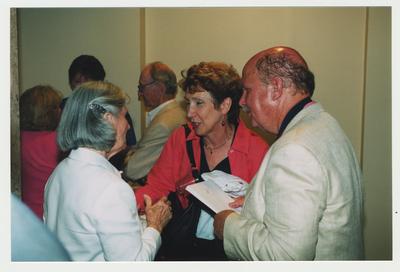Jerry Browning (right) and Ms. Green (center) are talking with Loretta Brock (left), spouse of Thomas Clark at Dr. Thomas D. Clark's 100th birthday celebration at Young Library.  In the background Len Press (center) and Lillian Press (left) are talking