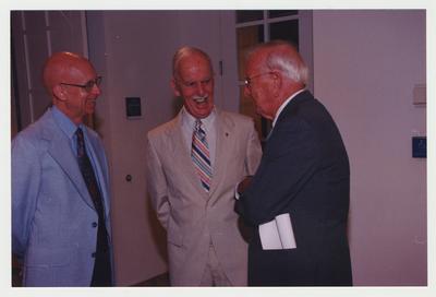 John Ed Pierce (right), Joe Houlihan (center), and an unidentified man (left) are talking at Dr. Thomas D. Clark's 100th birthday celebration at Young Library
