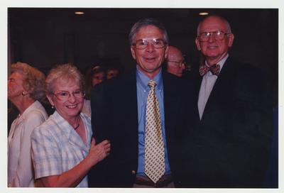 Jerry Crouch (far right), George Herring (center), History Professor, Dottie Leathers Herring (center, left) and Isabel Yates (far left) are talking at Dr. Thomas D. Clark's 100th birthday celebration at Young Library