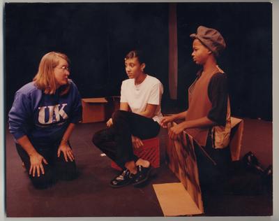An unidentified woman is talking with two unidentified African American children