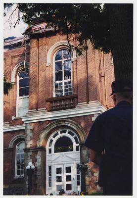 An unidentified man is standing outside the Administration / Main Building after the fire was extinguished