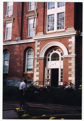 An unidentified men is standing outside of the Administration / Main Building during the fire