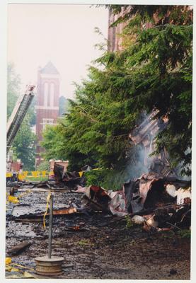 A pile of smoking debris on the ground outside of the Administration / Main Building