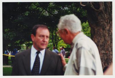 Former President Otis Singletary (right) is talking with President Wethington outside of the Administration / Main Building during the fire