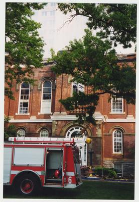 A fire truck is outside of the Administration / Main Building during the fire