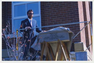 David Doss (left) with Messer Construction Company is next to the Time Capsule / Cornerstone dedication at the ceremony for the reopening of the Main Building