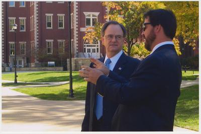 President Lee Todd (left) is talking with  David Doss (right), with Messer Construction Company, before the reopening of the Main Building