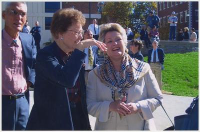 An unidentified woman is talking with Patsy Todd (right) during the ceremony for the reopening of the Main Building