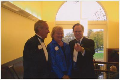 President Lee Todd (left) is talking with Diane Stuckert (center) and James W. Stuckert (right) at a ceremony for the reopening of the Main Building