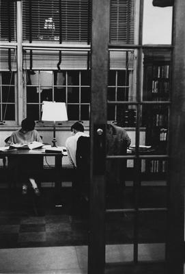 Students studying at night in the Browsing Room on the second floor of King Library. Received December of 1960 from Public Relations