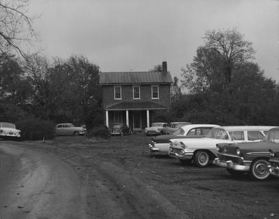 Photo of various cars parked in front of the Freeman House of the Medical School. Received November 2, 1959 from Public Relations