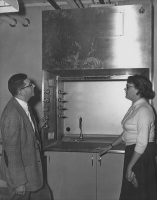 From left to right: Professor Robert Straus (College of Medicine) and an unidentified woman are inspecting equipment