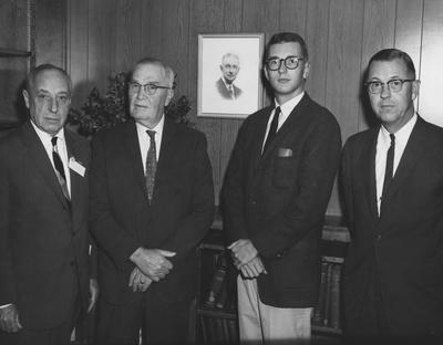 Four unidentified men stand together