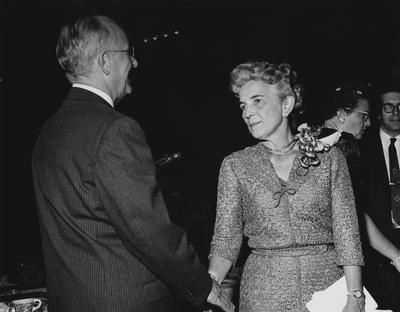 An unidentified woman and an unidentified man are shaking hands at the dedication of the Medical Center