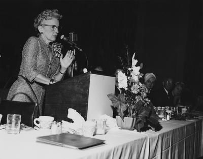 An unidentified woman is giving a speech at the dedication of the Medical Center