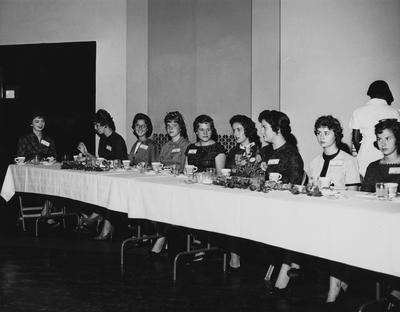 Unidentified women are sitting at a table at the dedication of the Medical Center