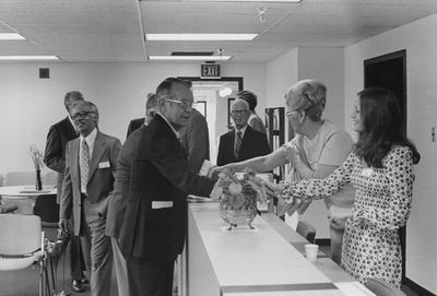 Wendell Ford shaking hands with unidentified people at the dedication of the Medical Center
