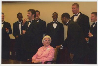Betty Rosenthal is with the UK men's choral group the Acoustikats at a ceremony for the reopening of the Main Building