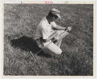Orville Whitaker is noting soil type on an aerial photograph