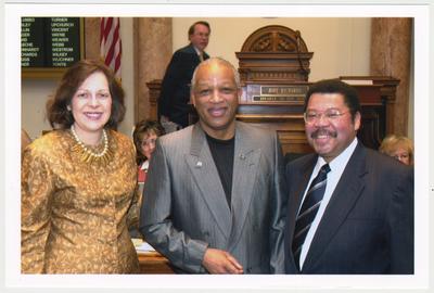 From the left:  Kentucky Representative Tanya Pullin; House Speaker Jody Richards; Cecil R. Madison, Sr., of UK Libraries; and Kentucky Representative Jesse Crenshaw.  The photograph was taken in the House Chamber