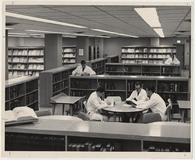 Unidentified men are reading in the Medical Center Library