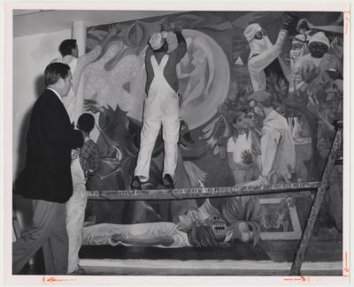 The mural in the Medical Center.  Artist Anton Refregier of New York is observing the installment of the mural that he painted.  The mural is named 