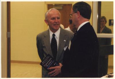 Peter Timoney (left), director of the Gluck Equine Research Center, speaks with UK President Lee Todd