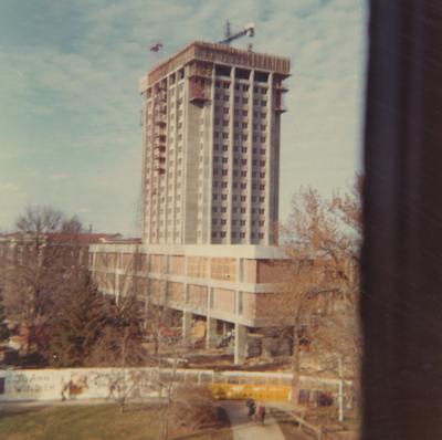 A color photo of the construction of White Hall Classroom Building (right) and Patterson Office Tower (next to White Hall) near the Administration Building (background). This photo was taken from the window in room 518 in King Library on December 9, 1968 and donated by Terry Warth