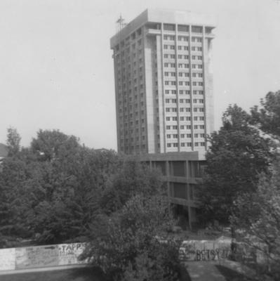 Unidentified men are dismantling the outside elevator of the Patterson Office Tower (next to White Hall). White Hall Classroom Building (right) is finishing constructions and is near Miller Hall (left). This photo was taken from the window in room 517 in King Library on May 5, 1969 and donated by Terry Warth
