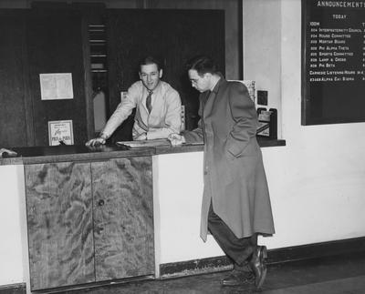 Student Union Desk. Gordon Godbery exchanges information with Henry Robertson. This photo appears on page 227 in the 1941 