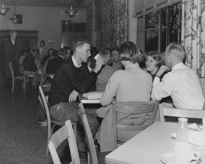Unidentified students drinking and socializing in the Student Union Building Cafeteria