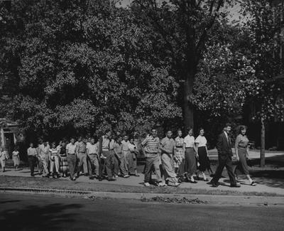 Group of people walking up Administration Drive in front of Barker Hall/Buell Armory. Photographer: Mack Hughes
