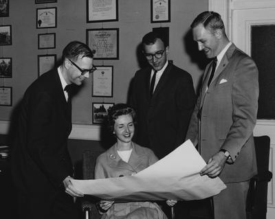 Students going abroad look at a map. Received April 13, 1962 from Public Relations