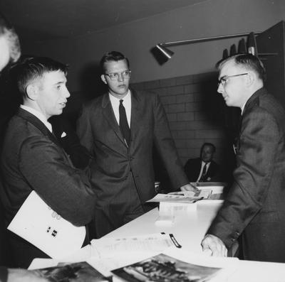 Three men talking at a Career Carnival. Photographer: Journal and Louisville Times; Gerald Griffin