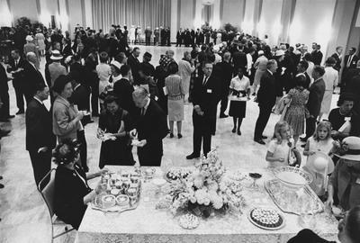 People mingling and eating at a gathering. Photographer: R. R. Rodney Boyce and Associates